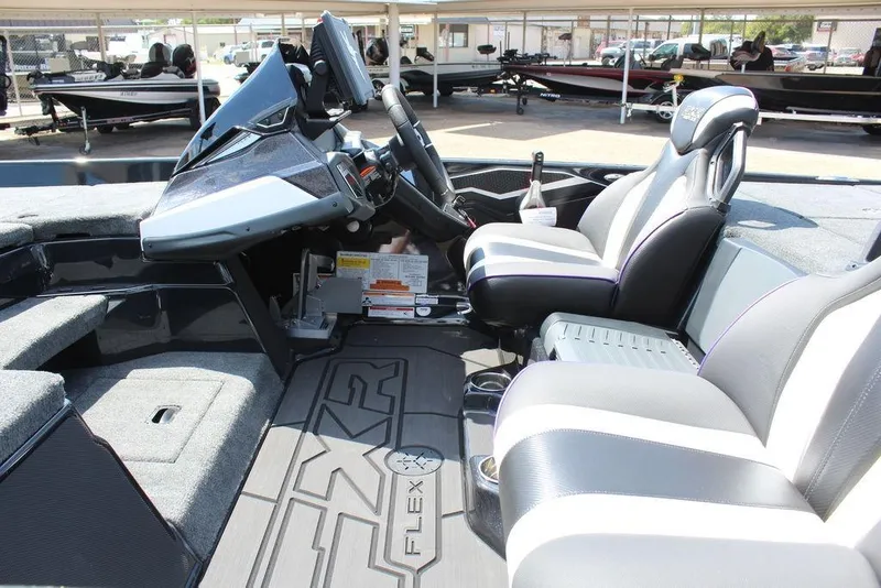 Slide: The Image of 2026 Skeeter FXR21 FLEX boat interior with modern dashboard and comfortable seating. - 9