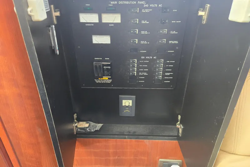 Slide: The Image of Electrical panel inside 2004 Sea Ray 480 Motor Yacht, featuring various switches and controls. - 10