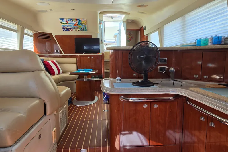 Slide: The Image of Luxurious interior of 2004 Sea Ray 480 Motor Yacht with leather seating and wooden cabinetry. - 15
