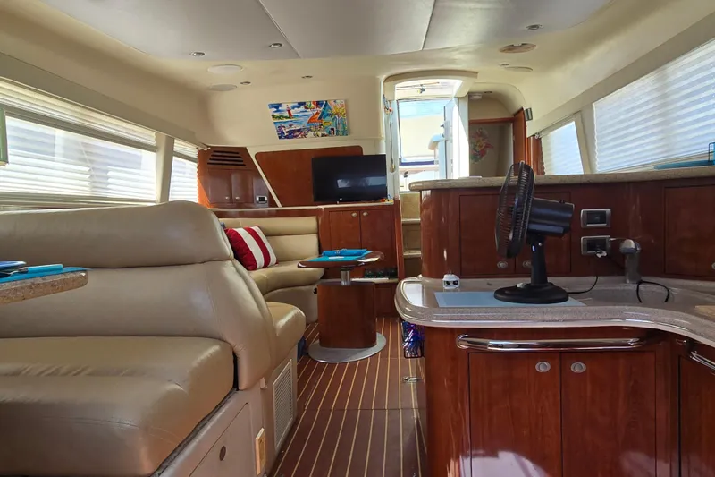 Slide: The Image of Luxurious interior of 2004 Sea Ray 480 Motor Yacht with leather seating and wood finishes. - 16
