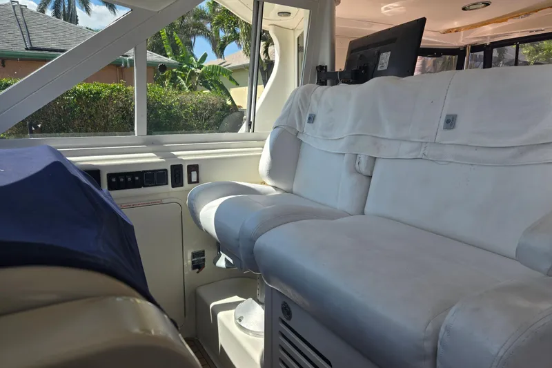 Slide: The Image of Interior of 2004 Sea Ray 480 Motor Yacht with white seating and windows. - 17