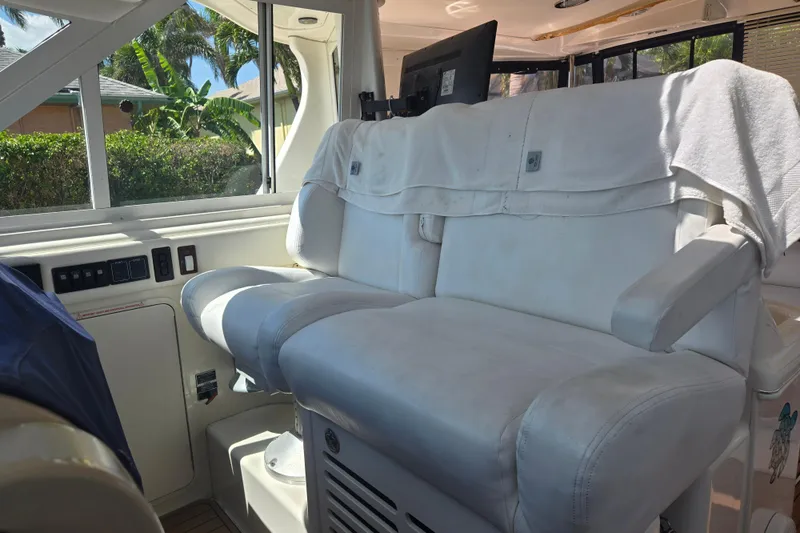 Slide: The Image of Luxurious interior seating of 2004 Sea Ray 480 Motor Yacht with white upholstery. - 18