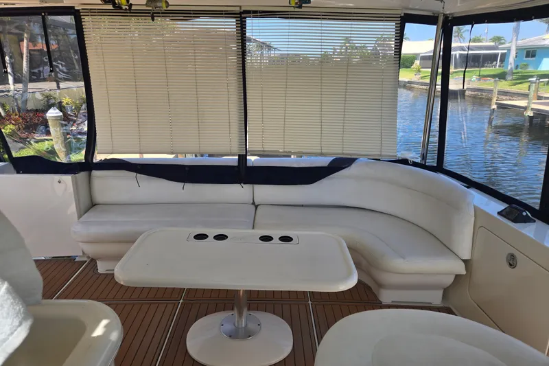 Slide: The Image of 2004 Sea Ray 480 Motor Yacht interior with white seating and wooden flooring. - 19