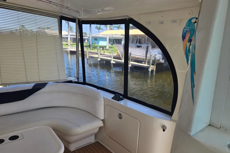 Slide: The Image of Interior of 2004 Sea Ray 480 Motor Yacht with waterfront view and parrot decor. - 21