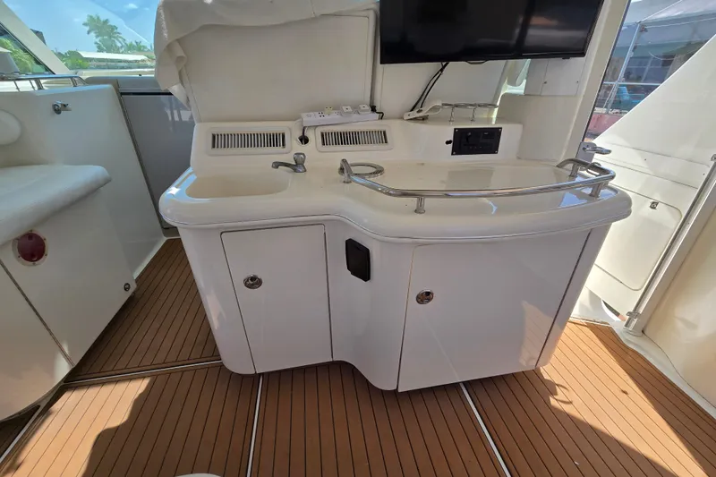 Slide: The Image of 2004 Sea Ray 480 Motor Yacht interior with sink and countertop on teak flooring. - 27