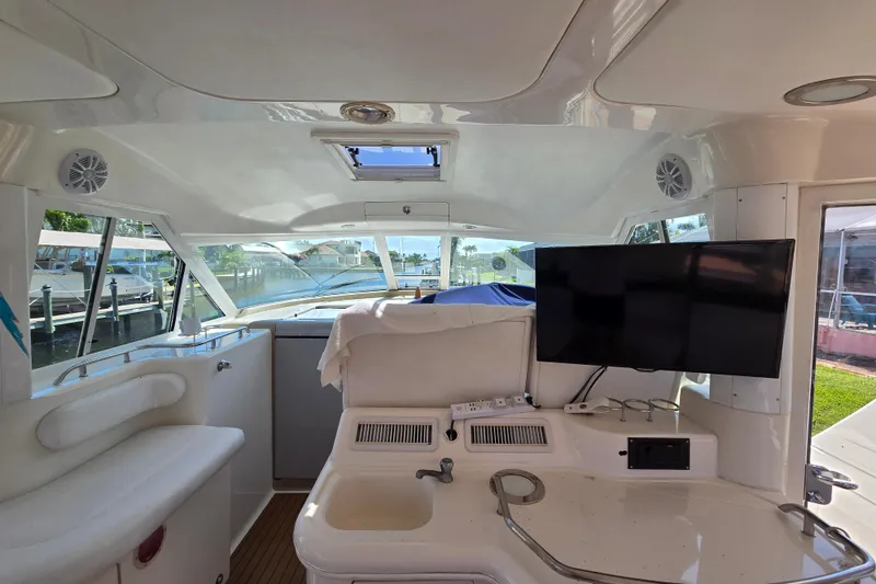 Slide: The Image of Interior of 2004 Sea Ray 480 Motor Yacht with seating and mounted TV. - 28
