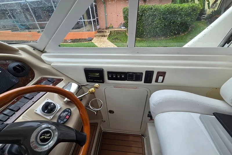 Slide: The Image of Interior helm of 2004 Sea Ray 480 Motor Yacht with steering wheel and control panel. - 32
