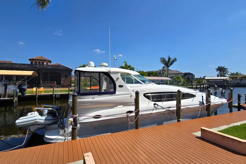 Slide: The Image of 2004 Sea Ray 480 Motor Yacht docked in a sunny marina setting. - 4