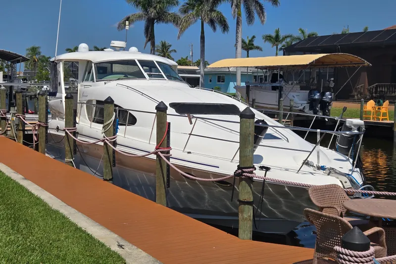 Slide: The Image of 2004 Sea Ray 480 Motor Yacht docked by palm trees, sunny day. - 5