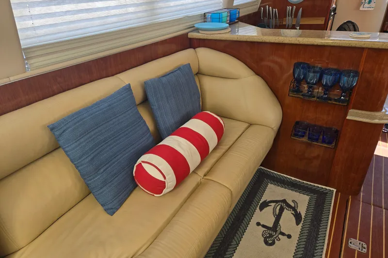 Slide: The Image of Luxurious interior of 2004 Sea Ray 480 Motor Yacht with cozy seating and nautical decor. - 9