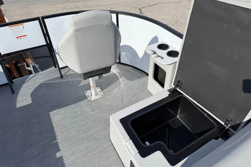 Slide: The Image of 2026 Lowe LF 194 boat interior with captain's chair, storage compartment, and cup holders. - 13