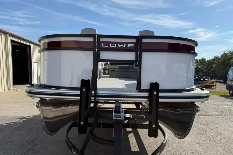 Slide: The Image of 2026 Lowe LF 194 pontoon boat on trailer, outdoor setting. - 2