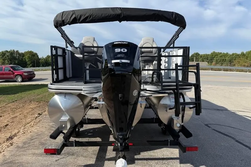 Slide: The Image of 2026 Lowe LF 194 pontoon boat with Mercury 90 engine, parked on a trailer. - 5