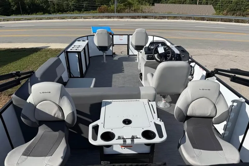 Slide: The Image of 2026 Lowe LF 194 pontoon boat interior with seating and steering console. - 6