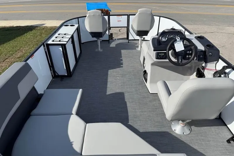 Slide: The Image of 2026 Lowe LF 194 boat interior with seating, steering console, and storage units. - 7