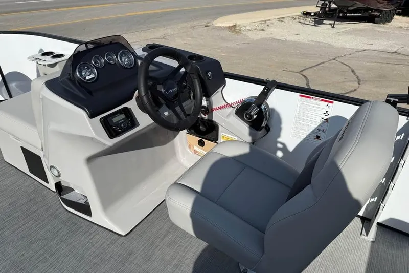 Slide: The Image of 2026 Lowe LF 194 boat cockpit with steering wheel and control panel. - 8