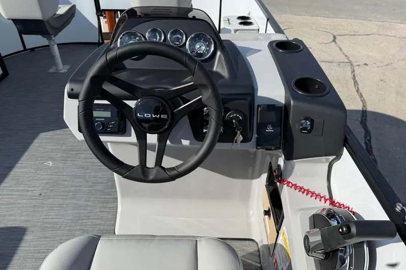 Slide: The Image of 2026 Lowe LF 194 boat dashboard with steering wheel and control panel. - 9