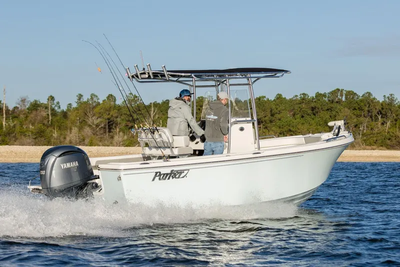 Slide: The Image of 2026 Parker 210 Coastal boat with Yamaha 150 outboard motor, parked on gravel. - 4