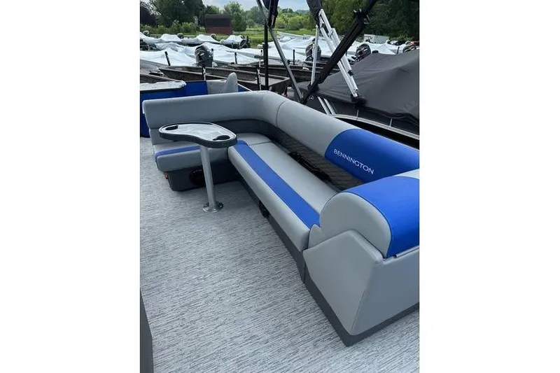 Slide: The Image of 2026 Bennington 23 SF Family boat with blue and gray seating, docked outdoors. - 16