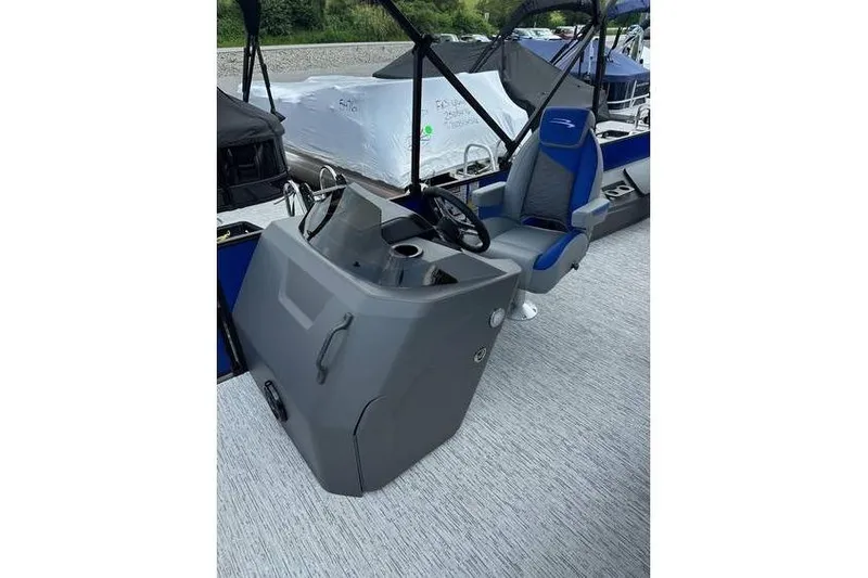 Slide: The Image of 2026 Bennington 23 SF Family boat interior with steering console and blue seat. - 17