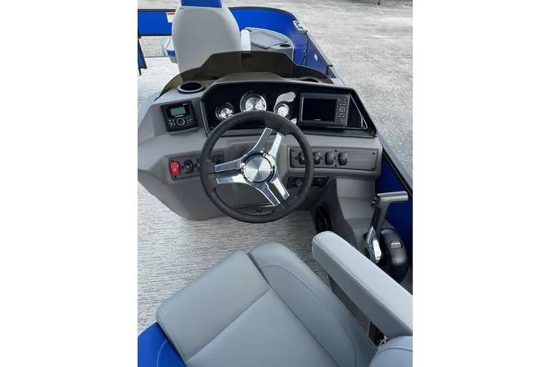 Slide: The Image of 2026 Bennington 23 SF Family boat dashboard with steering wheel and control panel. - 18
