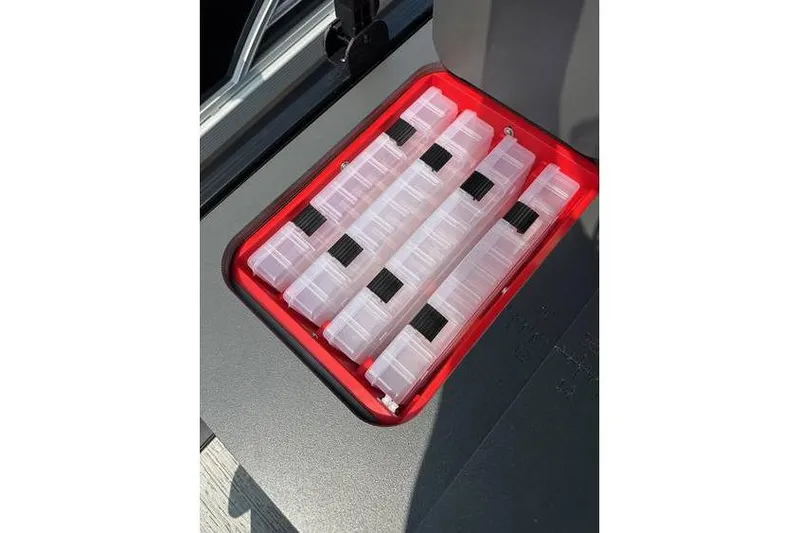 Slide: The Image of Storage compartment with organized tackle boxes on a 2026 Bennington 23 SF Family boat. - 27