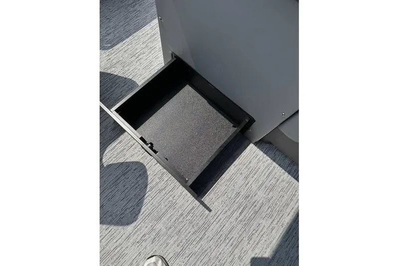 Slide: The Image of Open storage compartment on 2026 Bennington 23 SF Family / 4-Fish seat boat. - 29