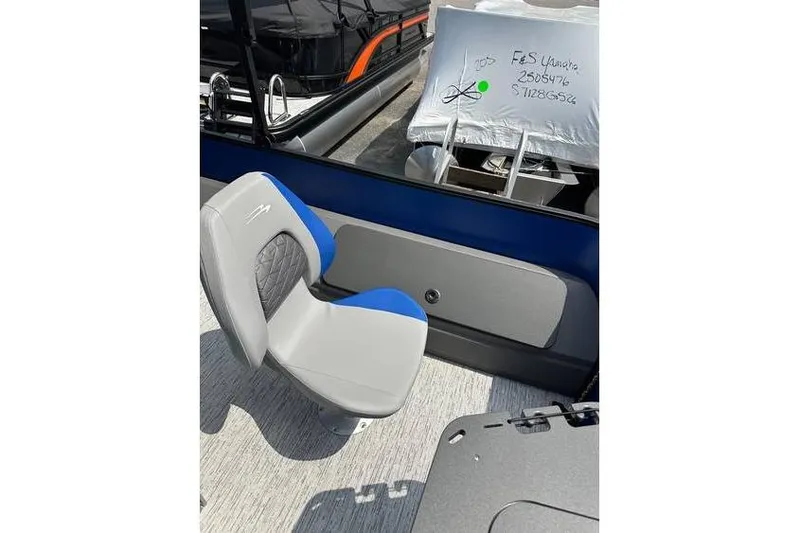 Slide: The Image of 2026 Bennington 23 SF Family boat with blue and gray seating, docked. - 34