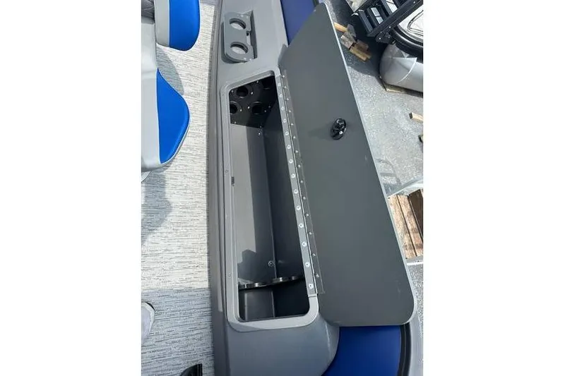 Slide: The Image of Open storage compartment on 2026 Bennington 23 SF Family boat with cup holders. - 35