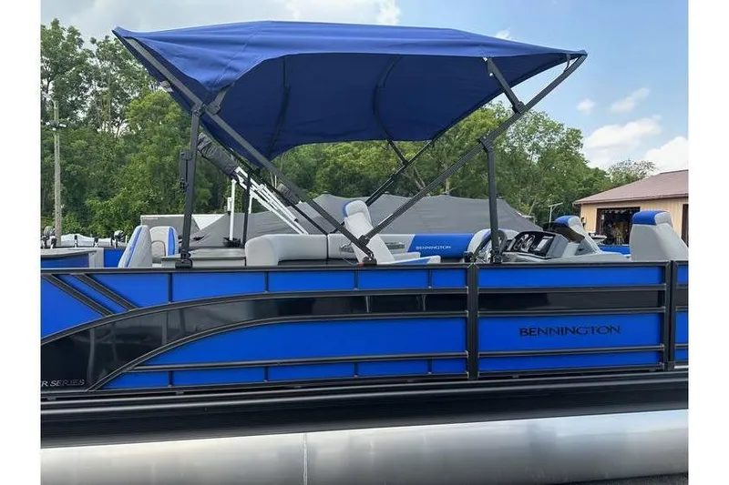 Slide: The Image of 2026 Bennington 23 SF Family pontoon boat with blue canopy and seating. - 40