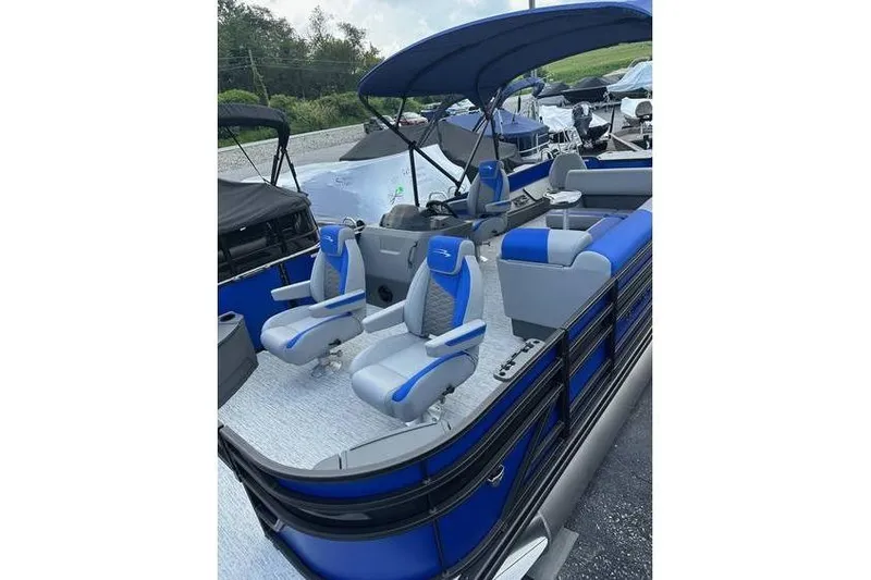 Slide: The Image of 2026 Bennington 23 SF Family boat with blue and gray seating, featuring a canopy. - 43