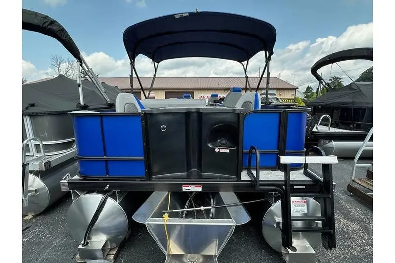Slide: The Image of 2026 Bennington 23 SF Family pontoon boat with blue accents and canopy. - 7