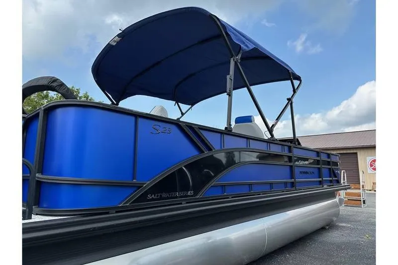 Slide: The Image of 2026 Bennington 23 SF Family pontoon boat with blue canopy and sleek design. - 8