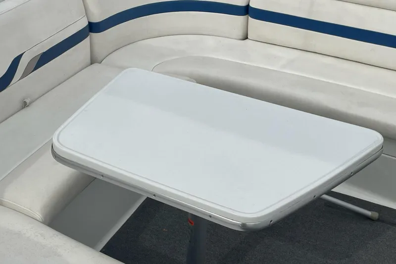 Slide: The Image of 2004 Formula 330 Sun Sport boat interior with white seating and table. - 12