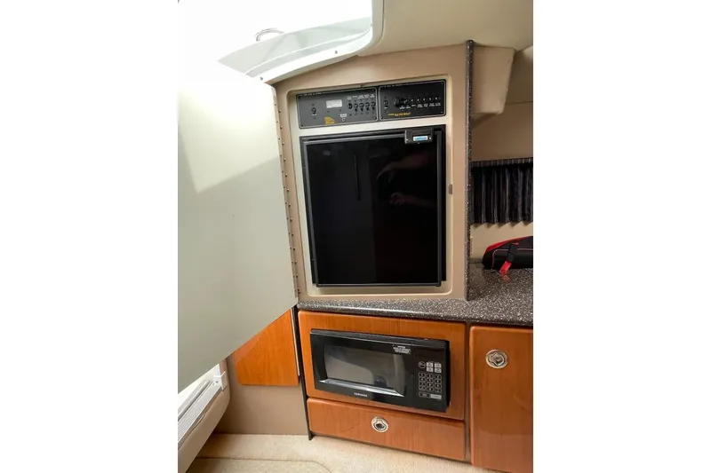 Slide: The Image of 2004 Formula 330 Sun Sport interior with fridge and microwave in cabin. - 15