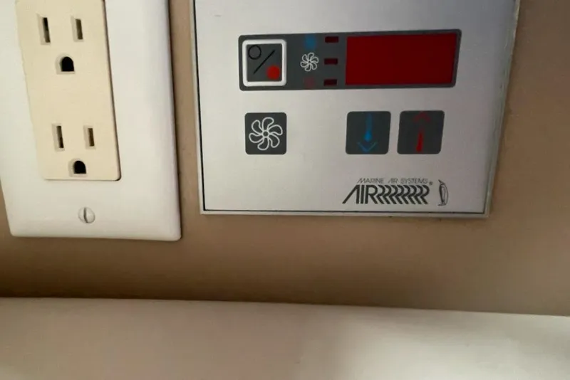 Slide: The Image of Control panel for marine air systems next to an electrical outlet on a Formula 330 Sun Sport. - 16