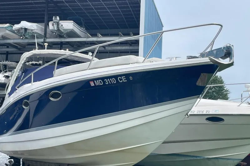 Slide: The Image of 2004 Formula 330 Sun Sport boat docked, blue and white exterior, registration MD 3110 CE. - 2