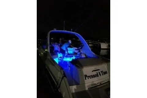 Slide: The Image of 2004 Formula 330 Sun Sport boat with blue interior lights at night. - 5