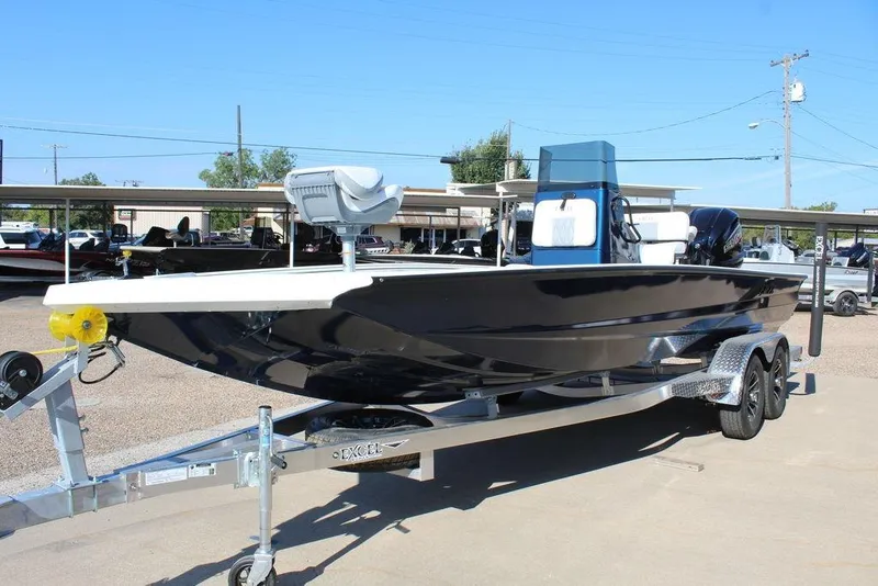 Slide: The Image of 2026 Excel Bay Pro Elite 220 boat on trailer, sleek design, parked outdoors. - 11