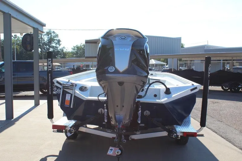 Slide: The Image of 2026 Excel Bay Pro Elite 220 boat on trailer, rear view in outdoor setting. - 3