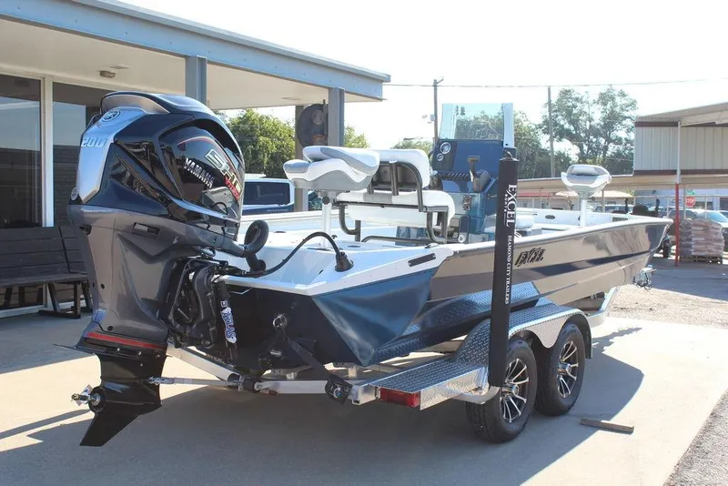 Slide: The Image of 2026 Excel Bay Pro Elite 220 boat with Yamaha engine on trailer, parked outdoors. - 6