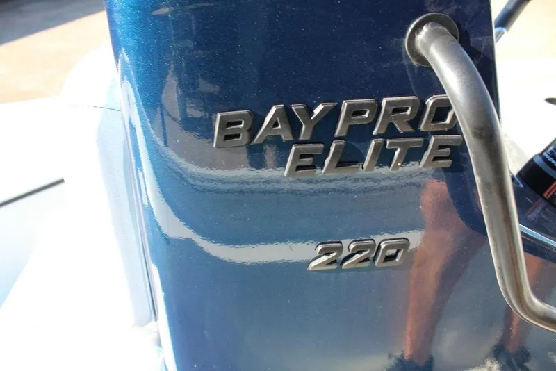 Slide: The Image of 2026 Excel Bay Pro Elite 220 boat logo on blue surface. - 8