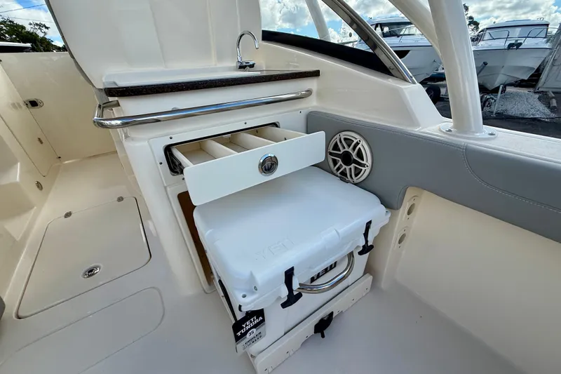 Slide: The Image of 2026 Scout 255 Dorado boat interior with storage and cooler. - 10