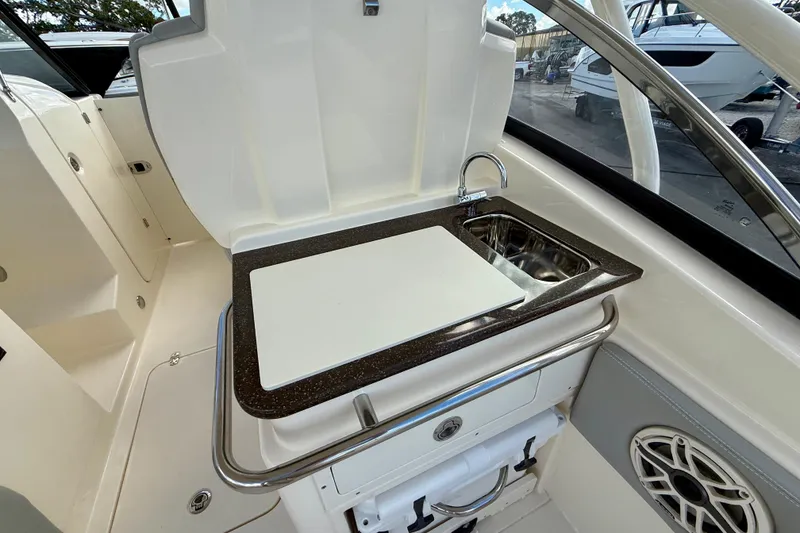 Slide: The Image of 2026 Scout 255 Dorado boat interior with sink and cutting board. - 11