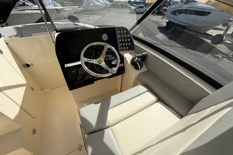 Slide: The Image of 2026 Scout 255 Dorado boat interior with steering wheel and control panel. - 20