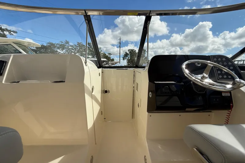 Slide: The Image of Interior view of 2026 Scout 255 Dorado boat with steering wheel and dashboard. - 21