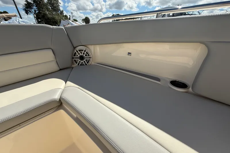 Slide: The Image of 2026 Scout 255 Dorado boat interior with cushioned seating and speaker detail. - 26