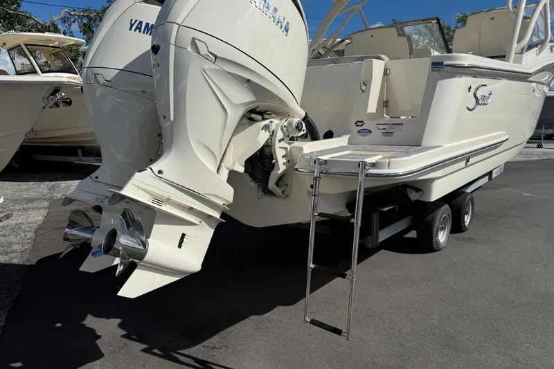 Slide: The Image of 2026 Scout 255 Dorado boat with Yamaha engines and ladder on trailer. - 28