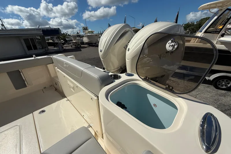 Slide: The Image of 2026 Scout 255 Dorado boat with dual Yamaha engines and open storage compartment. - 29