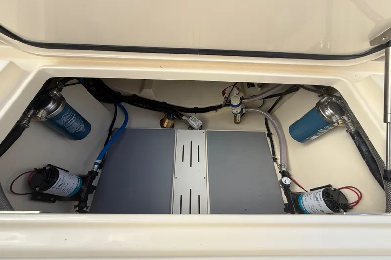 Slide: The Image of 2026 Scout 255 Dorado boat compartment with pumps and filters. - 32